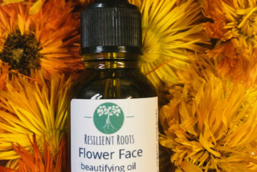 bottle of flower face beautifying oil made with calendula flowers